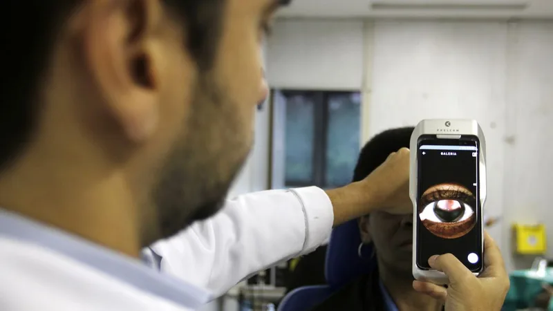 O Dr. Flávio Medina realiza exame de fundo de olho com um retinógrafo portátil,